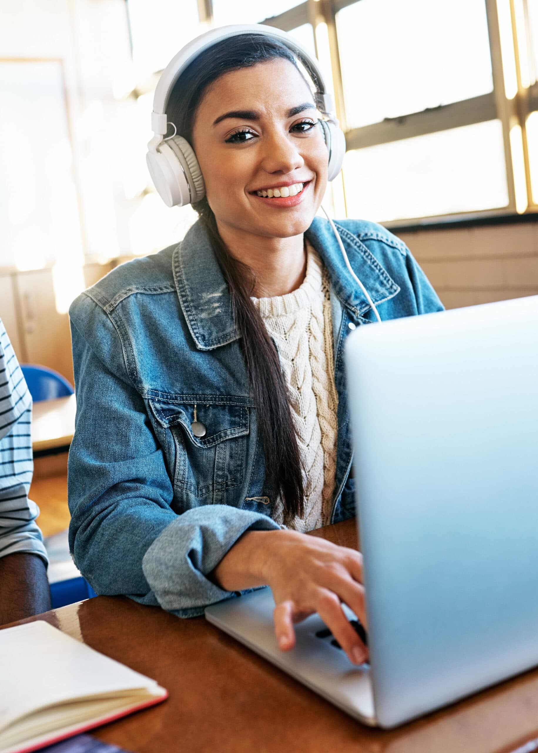 Smiling student giving a thumbs up while studying