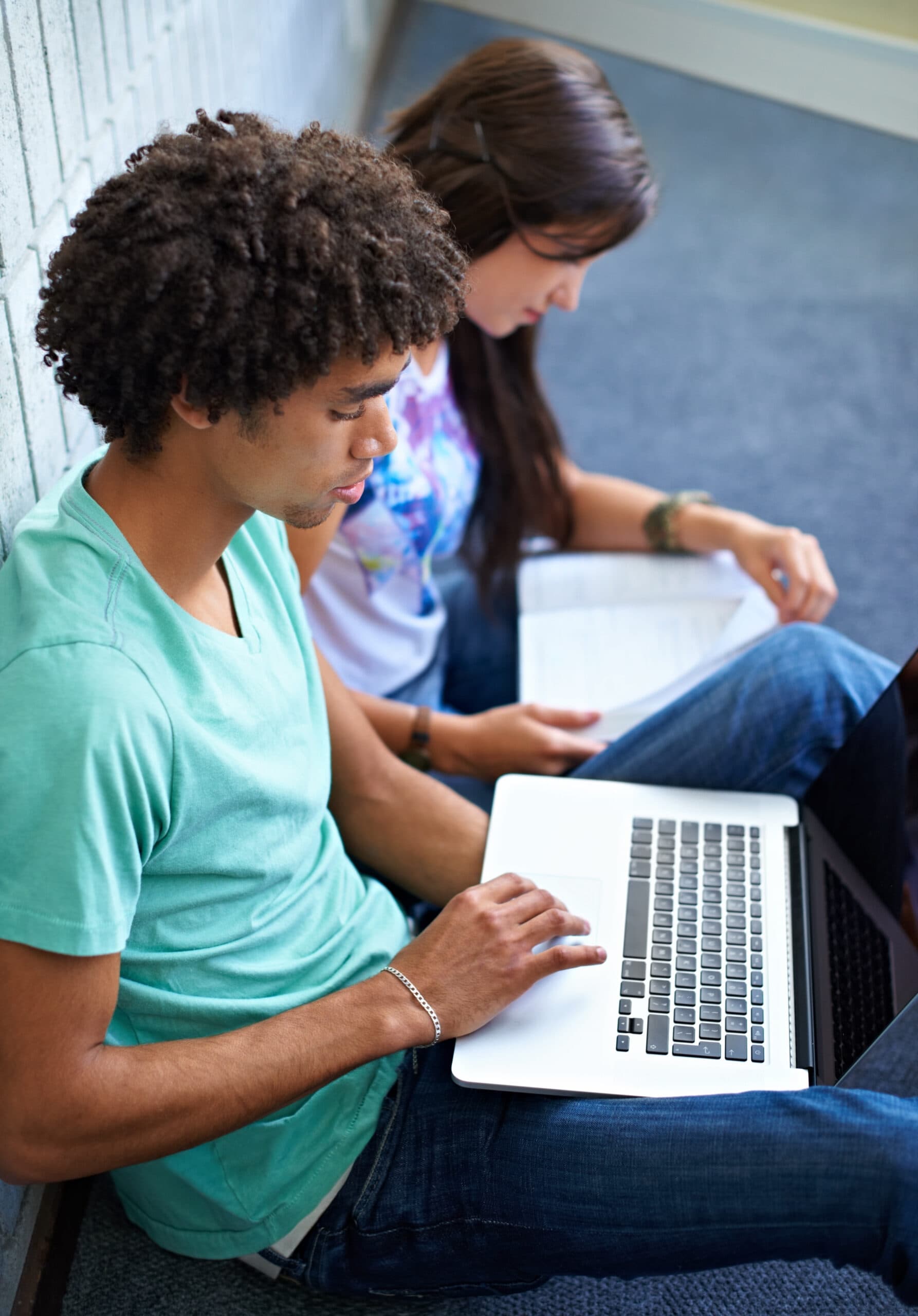 Student using research resources in the library